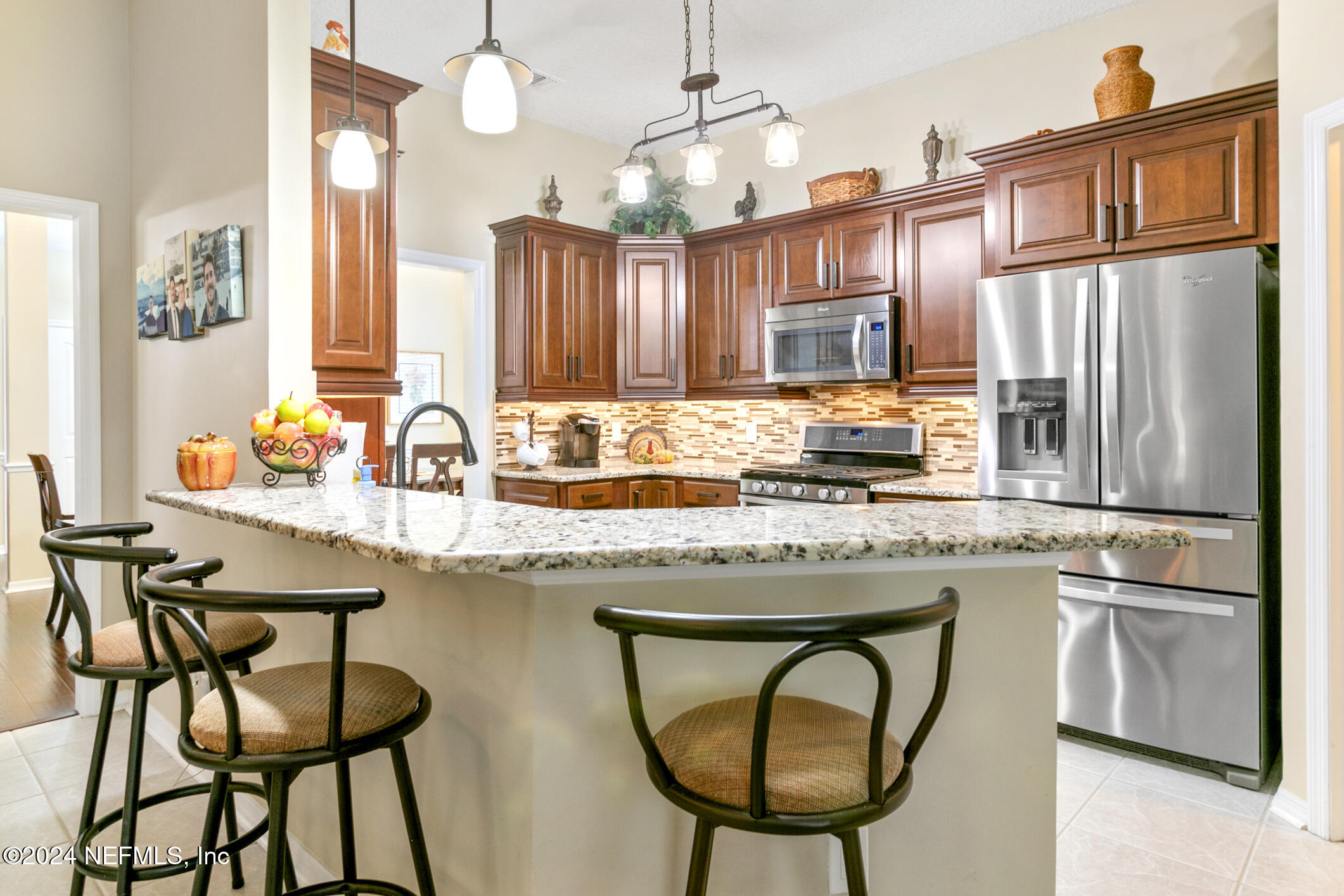 540 Moultrie Wells Road St. Augustine, FL 32086 - Photo 30 of 44 a kitchen with stainless steel appliances granite countertop a stove a sink and a refrigerator
