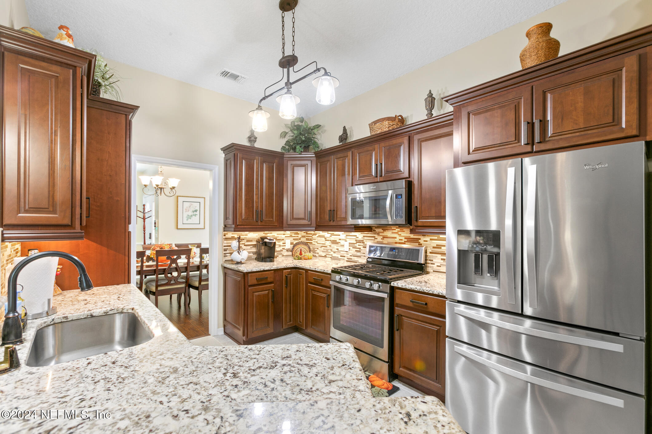 540 Moultrie Wells Road St. Augustine, FL 32086 - Photo 31 of 44 a kitchen with stainless steel appliances granite countertop a refrigerator a stove a sink a oven and a refrigerator