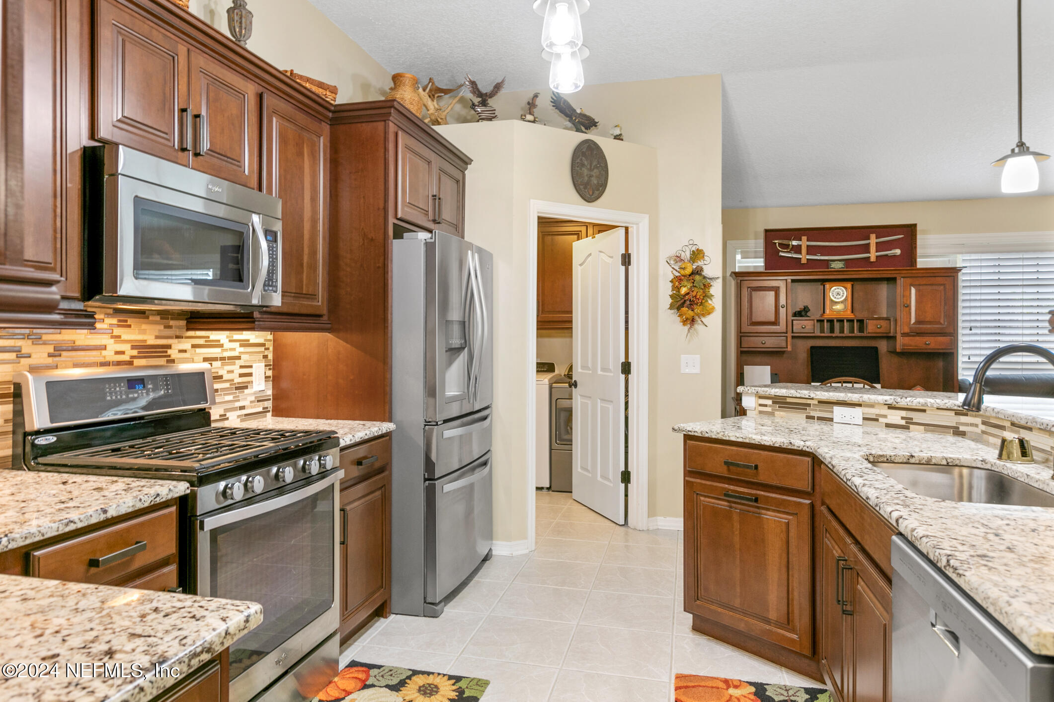 540 Moultrie Wells Road St. Augustine, FL 32086 - Photo 34 of 44 a kitchen with stainless steel appliances granite countertop a stove sink and refrigerator