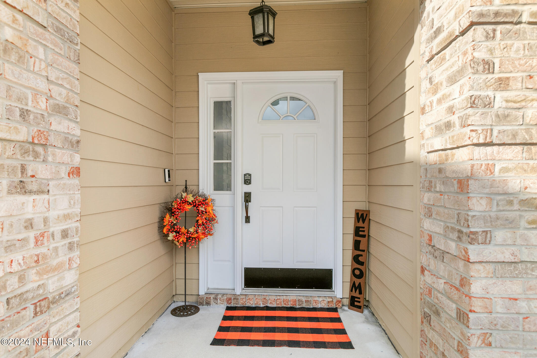 540 Moultrie Wells Road St. Augustine, FL 32086 - Photo 4 of 44 a vase of flowers sitting on a brick wall