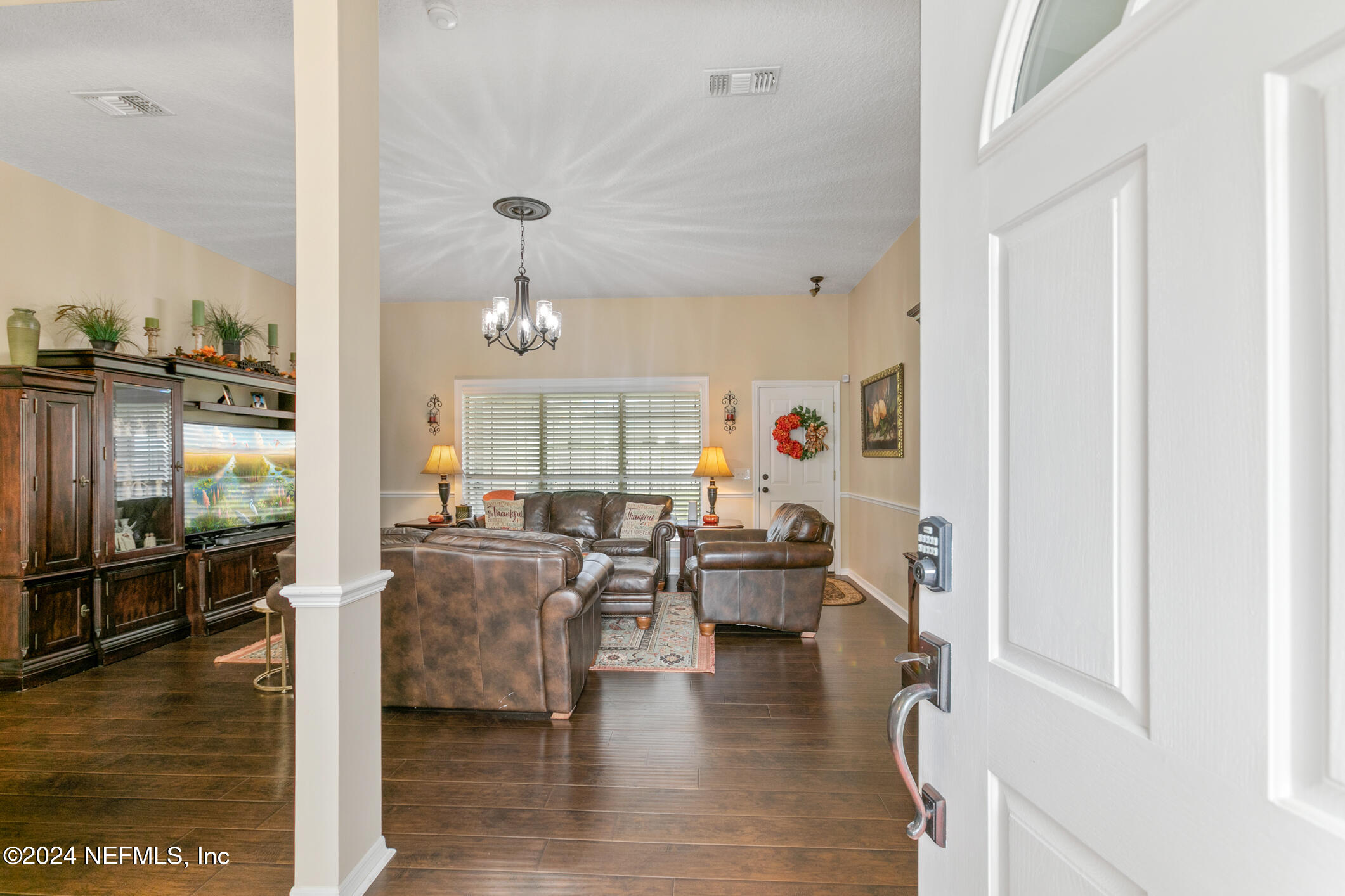 540 Moultrie Wells Road St. Augustine, FL 32086 - Photo 5 of 44 a living room with fireplace furniture and a floor to ceiling window