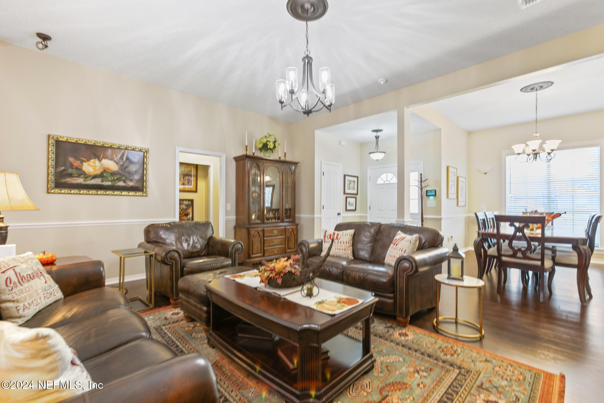540 Moultrie Wells Road St. Augustine, FL 32086 - Photo 9 of 44 a living room with furniture a dining table and a chandelier