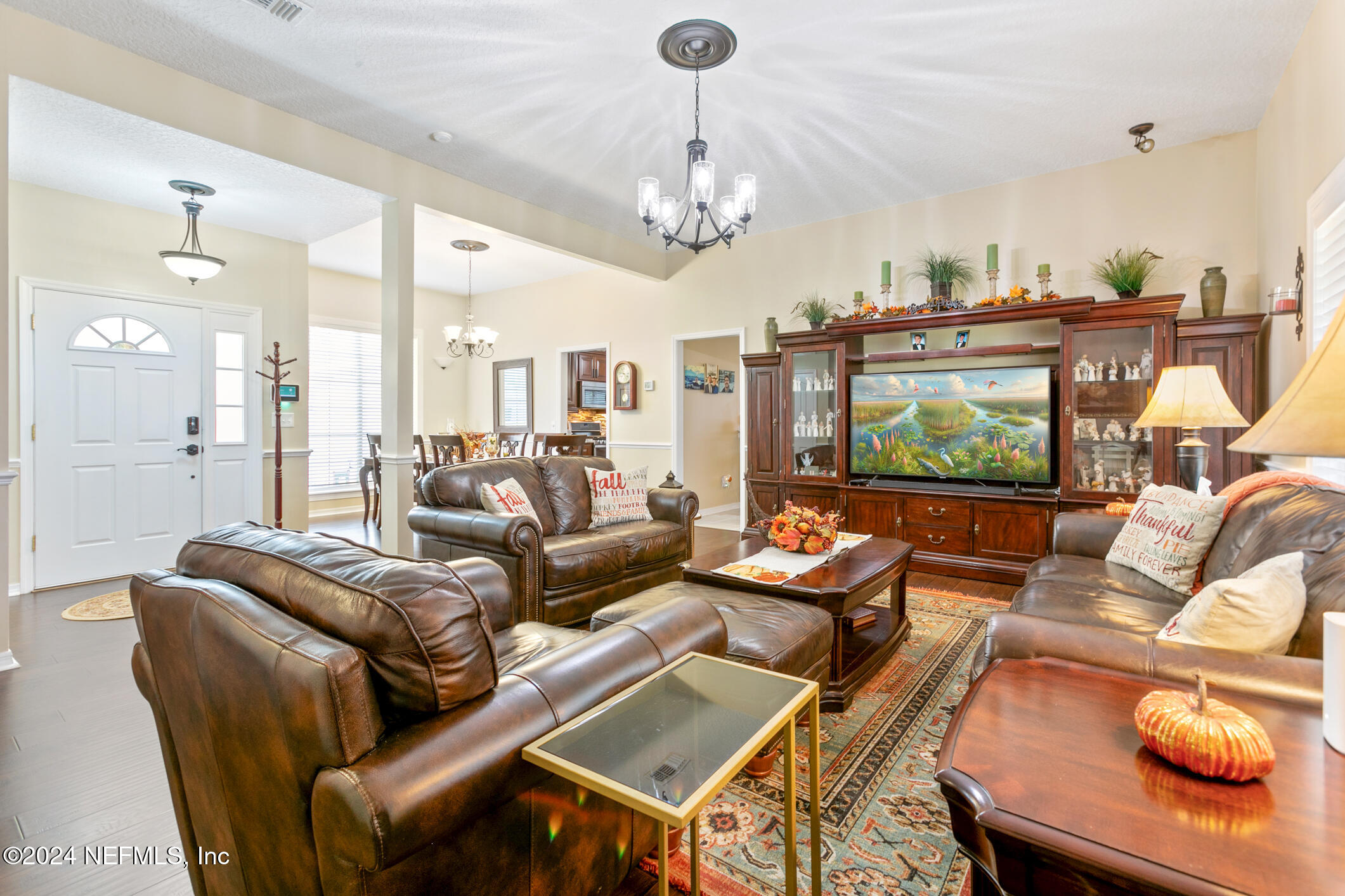 540 Moultrie Wells Road St. Augustine, FL 32086 - Photo 10 of 44 a living room with furniture a chandelier and a large window