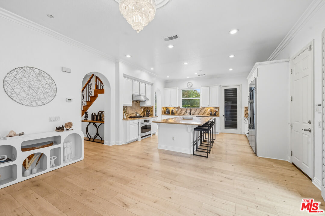 22074 Sagebrook Road Chatsworth, CA 91311 - Photo 15 of 35 a open kitchen with stainless steel appliances kitchen island a refrigerator and a stove top oven