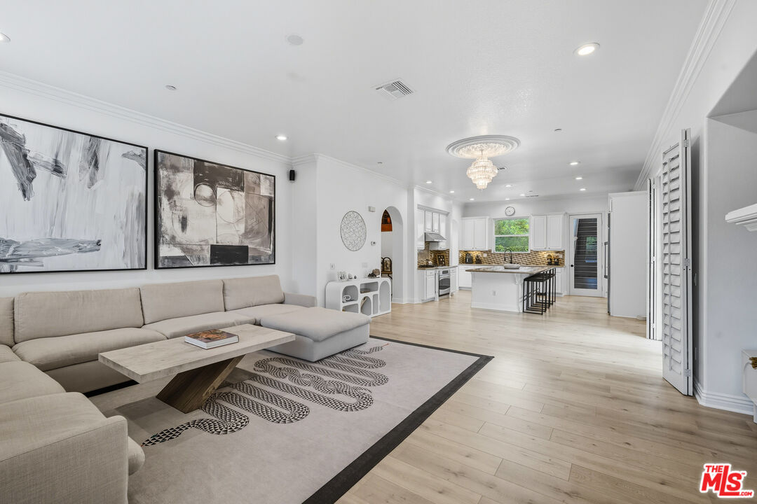 22074 Sagebrook Road Chatsworth, CA 91311 - Photo 18 of 35 a living room with furniture kitchen view and a wooden floor