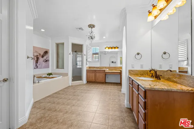 a bathroom with a granite countertop sink a bathtub and a shower