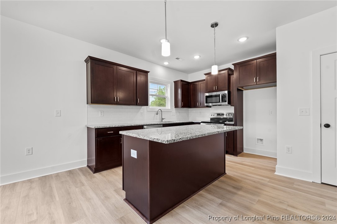 2902 Calloway (lot 1) Road Raeford, NC 28376 - Photo 20 of 44 a kitchen with stainless steel appliances granite countertop a stove a refrigerator and a microwave oven