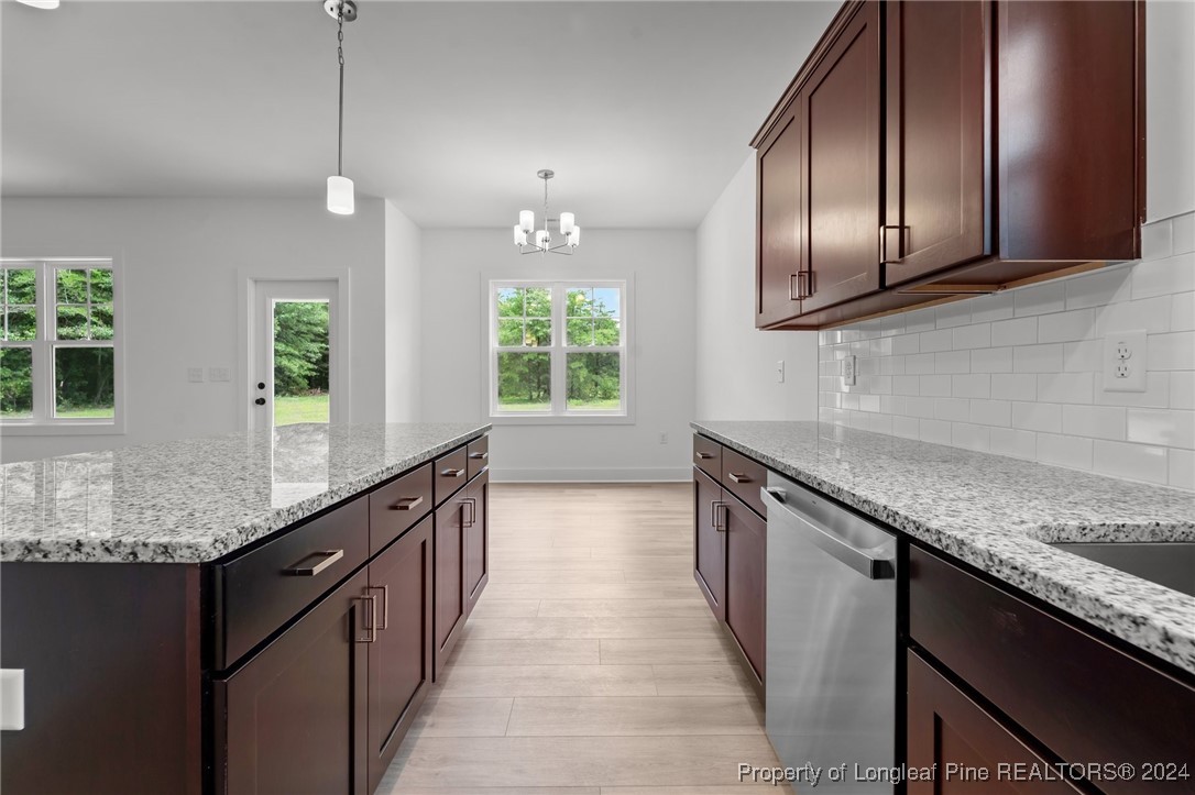 2902 Calloway (lot 1) Road Raeford, NC 28376 - Photo 23 of 44 a kitchen with granite countertop stainless steel appliances and wooden cabinets