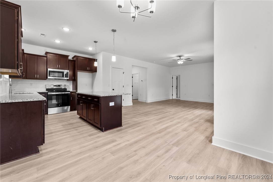 2902 Calloway (lot 1) Road Raeford, NC 28376 - Photo 25 of 44 a kitchen with stainless steel appliances kitchen island wooden cabinets and granite counter tops