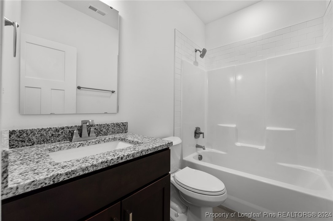 2902 Calloway (lot 1) Road Raeford, NC 28376 - Photo 34 of 44 a bathroom with a granite countertop sink a toilet and shower