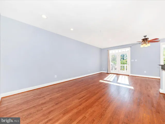 a view of kitchen and hall with wooden floor