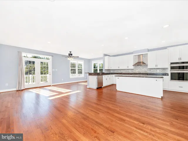 a view of a room with wooden floor and white walls