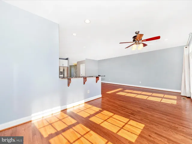 a kitchen with granite countertop a stove and a wooden floor