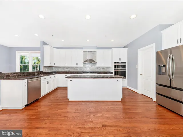 a kitchen with granite countertop white cabinets and a granite counter tops