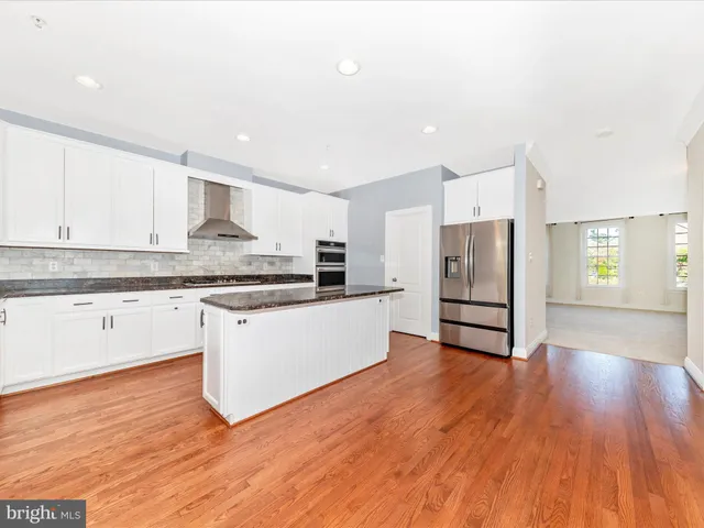 a bathroom with a granite countertop sink mirror vanity and toilet