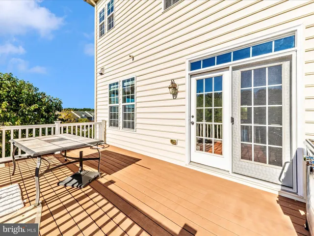 a view of balcony with wooden floor and fence