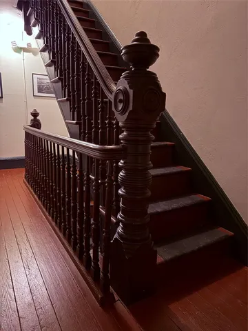 a view of an empty room with cabinet and a window