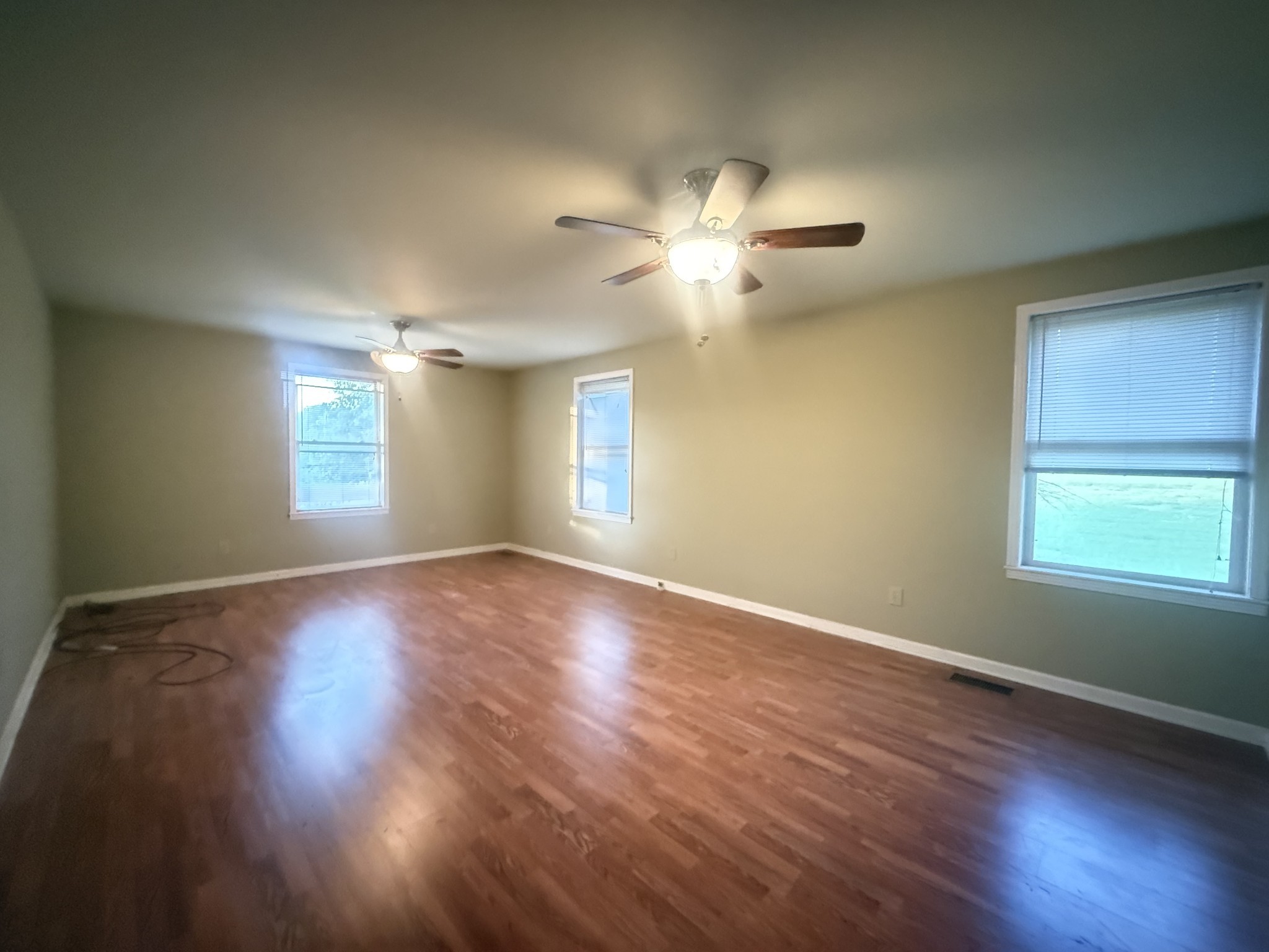 191 Cooks Rd Extension Lebanon, TN 37087 - Photo 16 of 33 a view of an empty room with a window and wooden floor