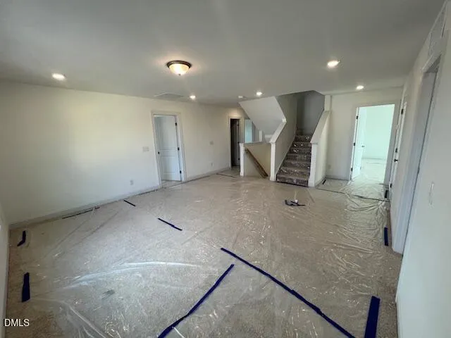 an empty room with a fireplace and windows