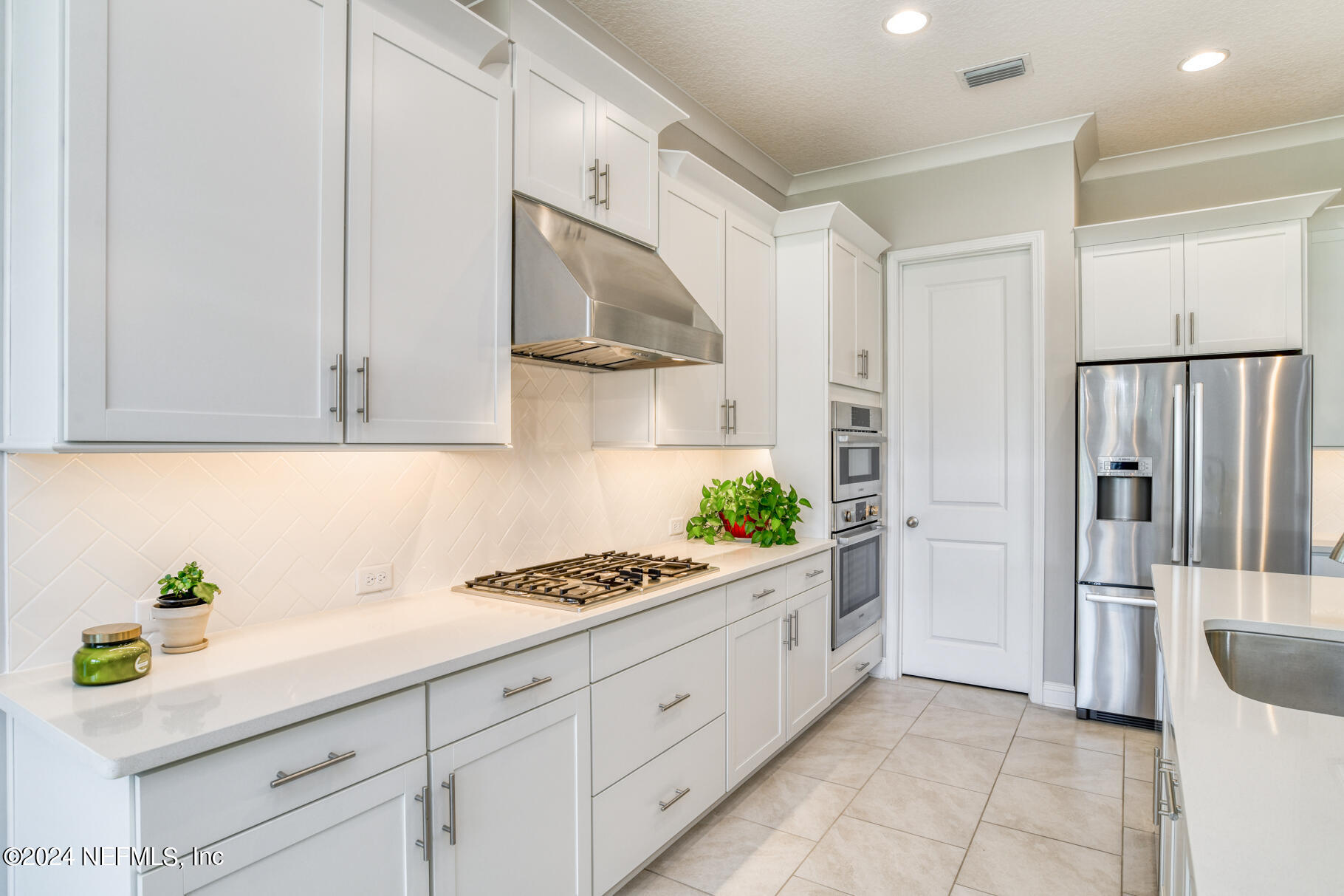 405 Pintoresco Drive St. Augustine, FL 32095 - Photo 11 of 51 a kitchen with stainless steel appliances kitchen island granite countertop a refrigerator and a sink