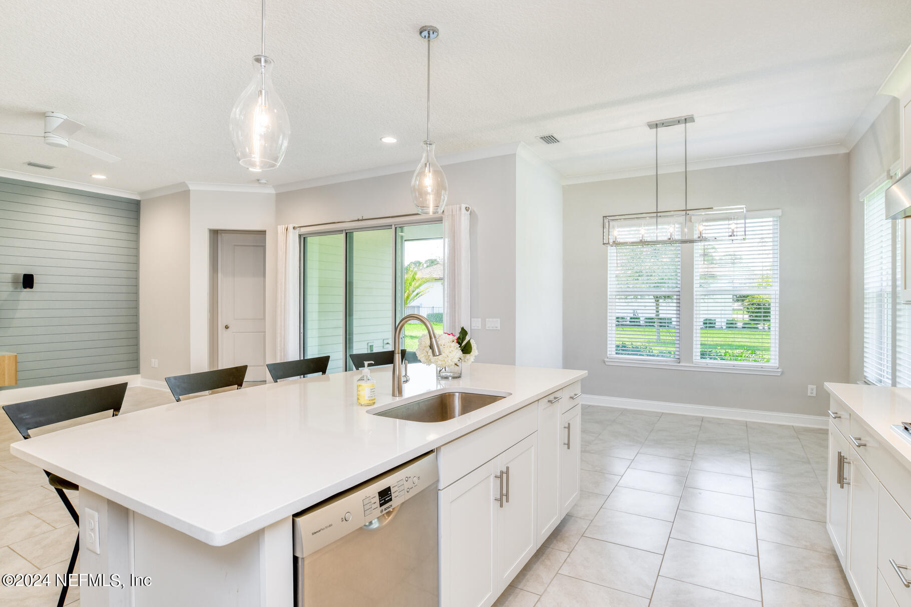 405 Pintoresco Drive St. Augustine, FL 32095 - Photo 14 of 51 a kitchen with a sink a large window and chairs