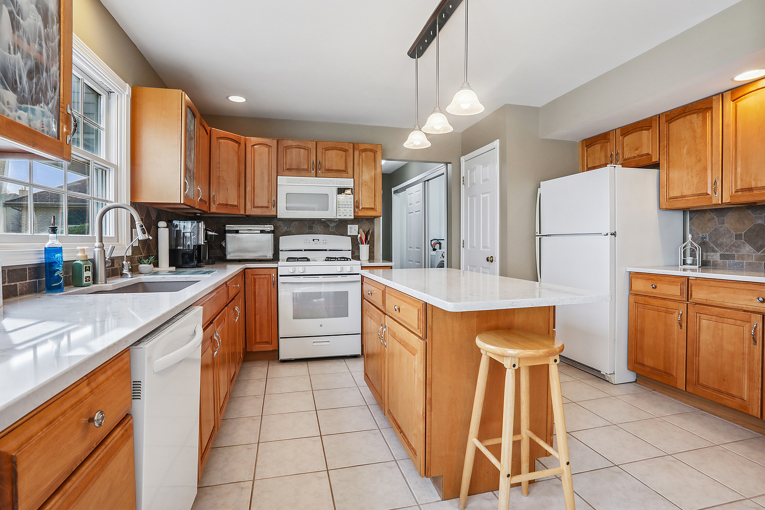 385 Coventry Lane Crete, IL 60417 - Photo 6 of 24 a large kitchen with stainless steel appliances kitchen island granite countertop a sink and cabinets