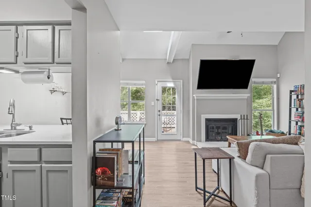 a living room with furniture fireplace and flat screen tv
