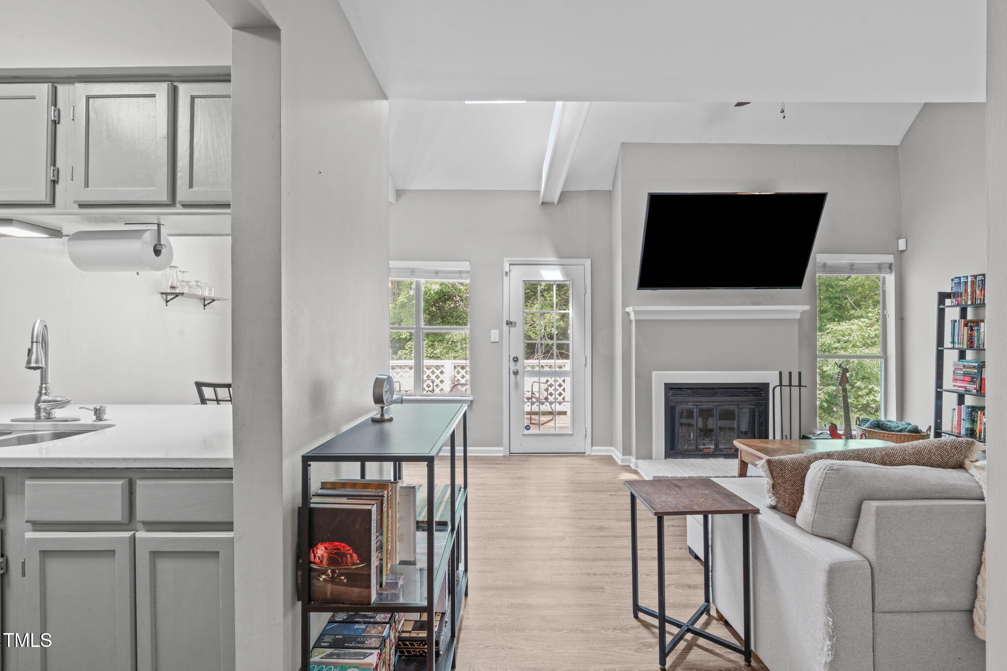 a living room with furniture fireplace and flat screen tv