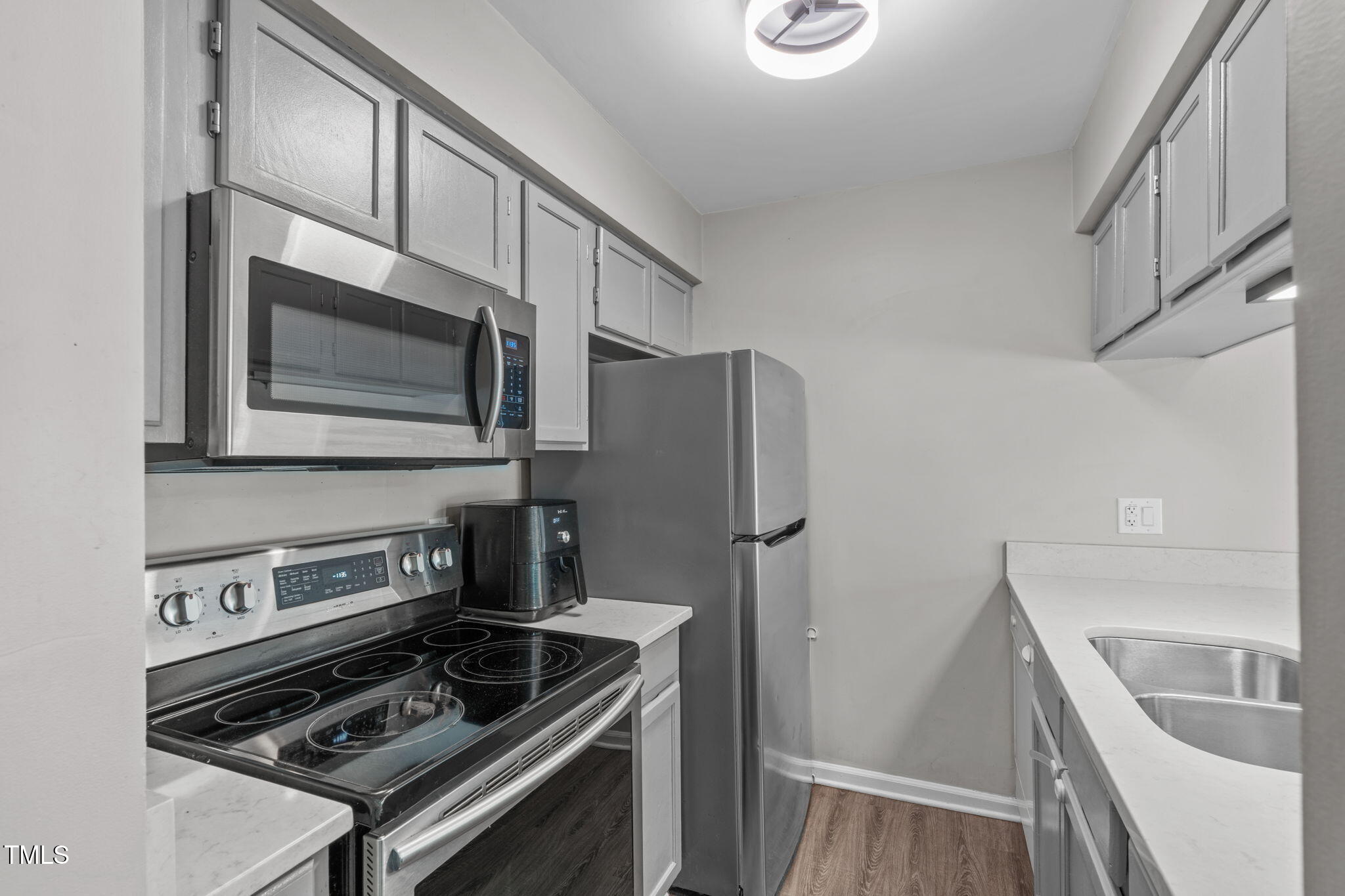 405 Gooseneck Drive, Unit B6 Cary, NC 27513 - Photo 11 of 26 a kitchen with stainless steel appliances a stove a microwave and a refrigerator