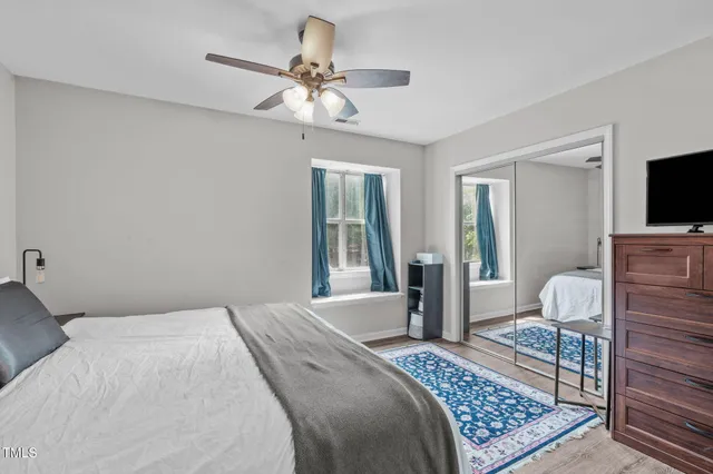 a bathroom with a granite countertop sink a toilet and a mirror
