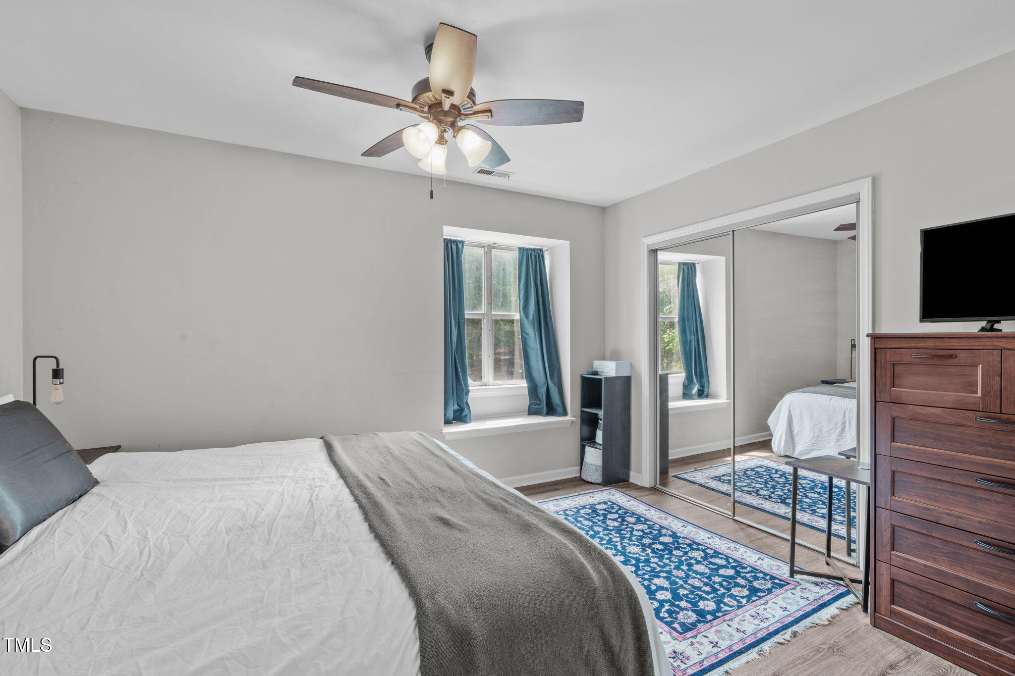 405 Gooseneck Drive, Unit B6 Cary, NC 27513 - Photo 14 of 26 a bedroom with a bed and a flat screen tv