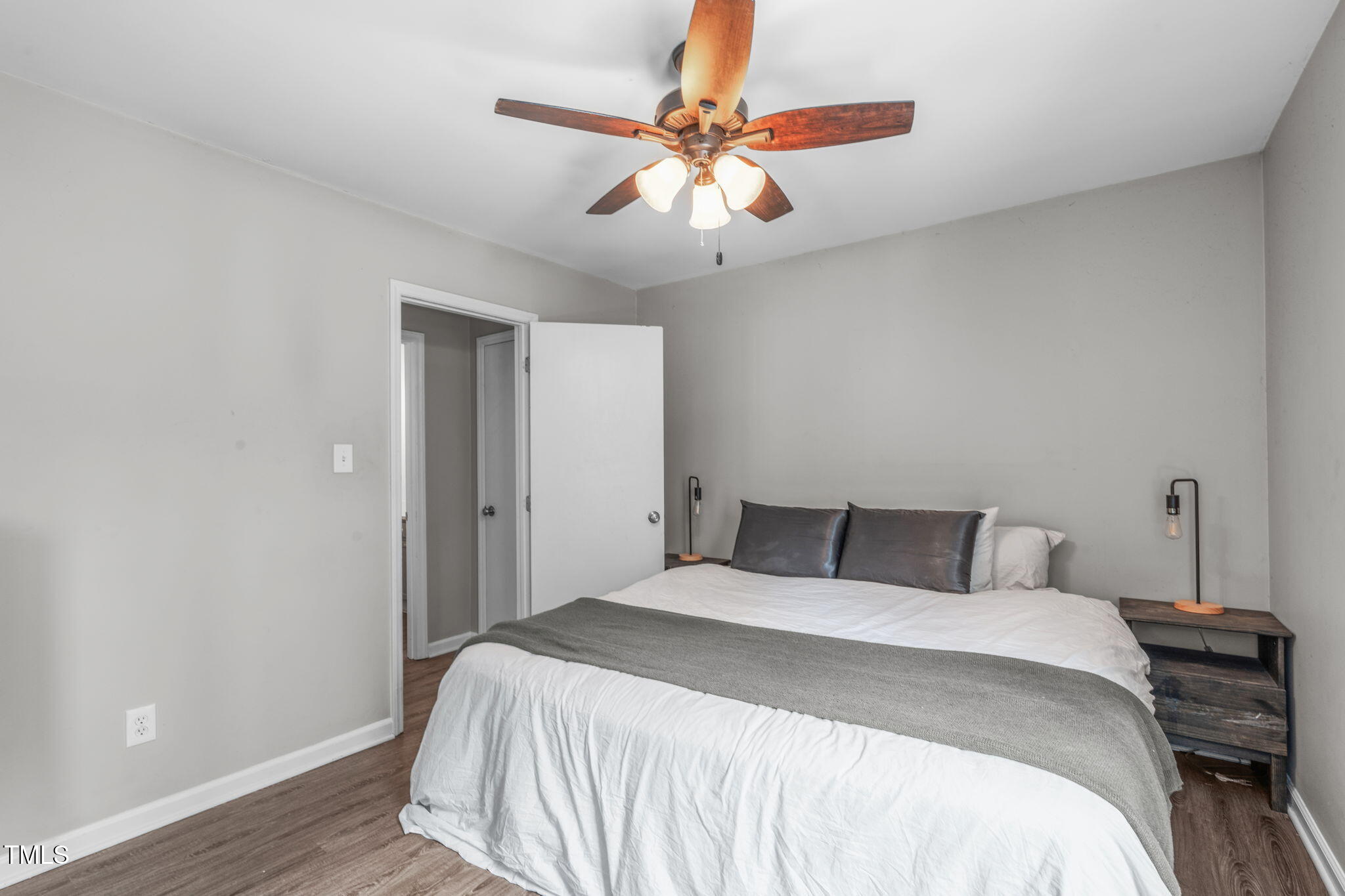 405 Gooseneck Drive, Unit B6 Cary, NC 27513 - Photo 15 of 26 a bedroom with a bed and a ceiling fan