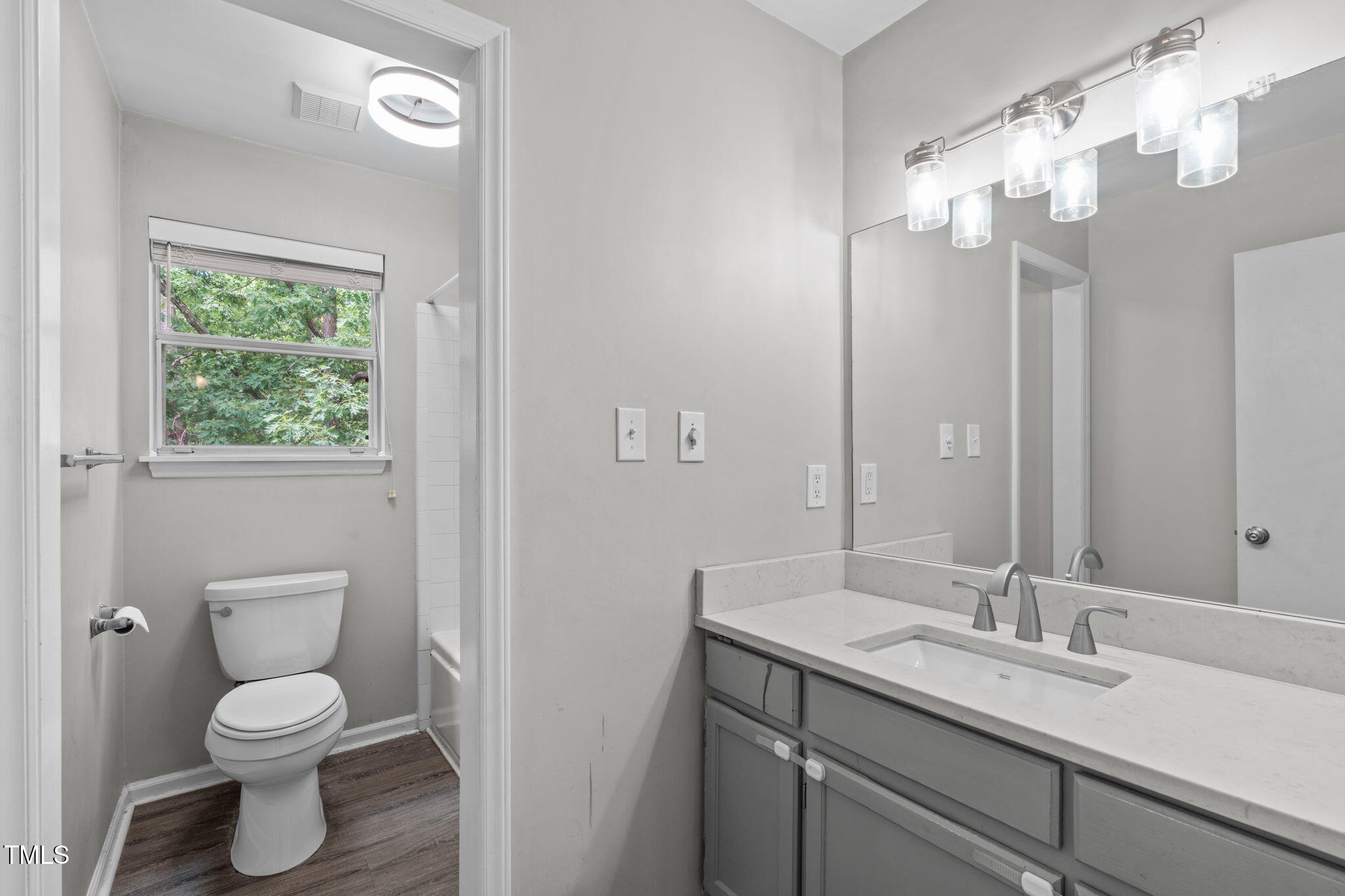 405 Gooseneck Drive, Unit B6 Cary, NC 27513 - Photo 16 of 26 a bathroom with a granite countertop sink a toilet and a mirror