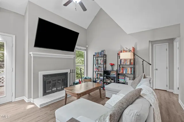 a living room with furniture fireplace and flat screen tv