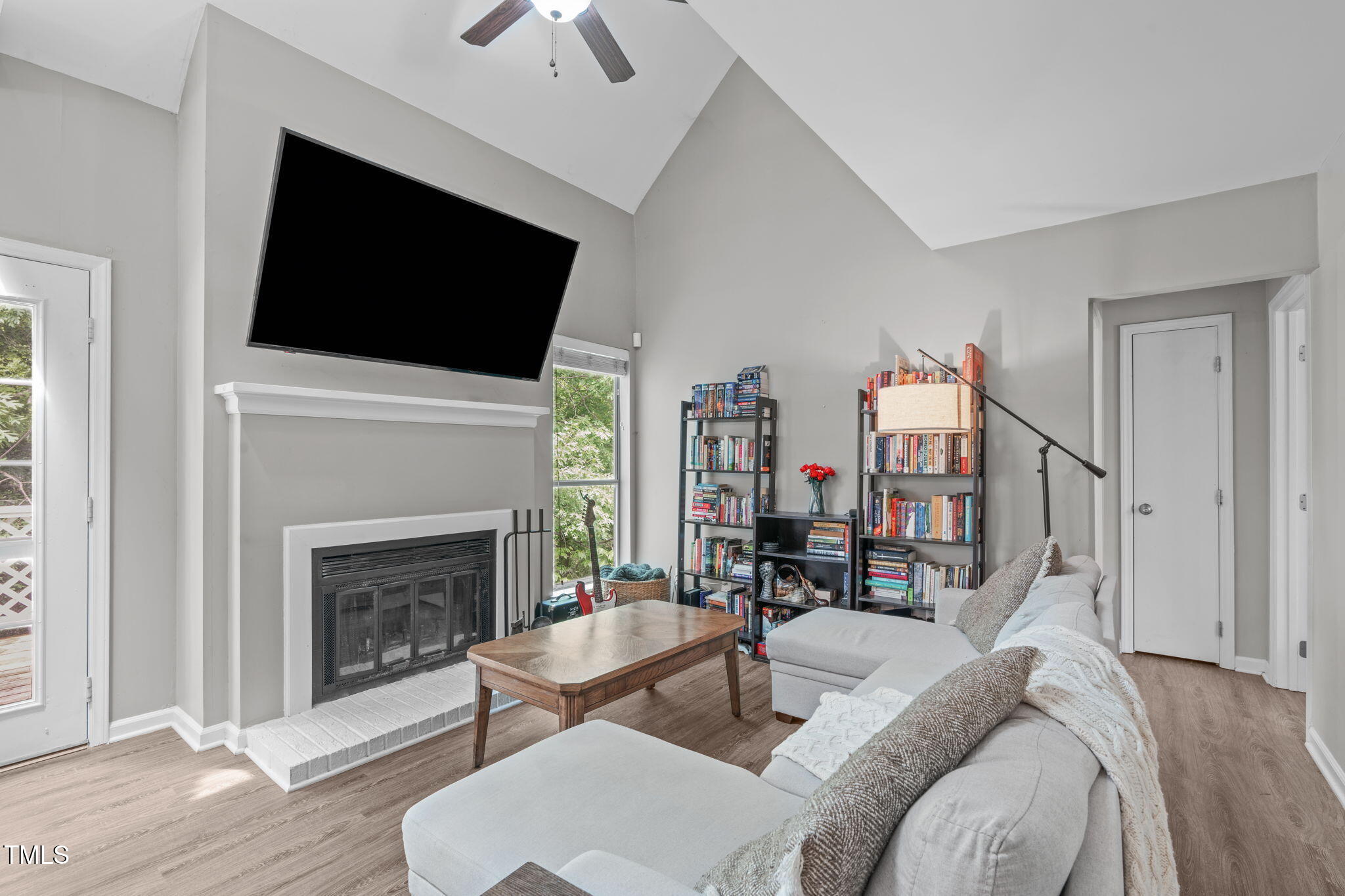 405 Gooseneck Drive, Unit B6 Cary, NC 27513 - Photo 6 of 26 a living room with furniture a fireplace and a flat screen tv