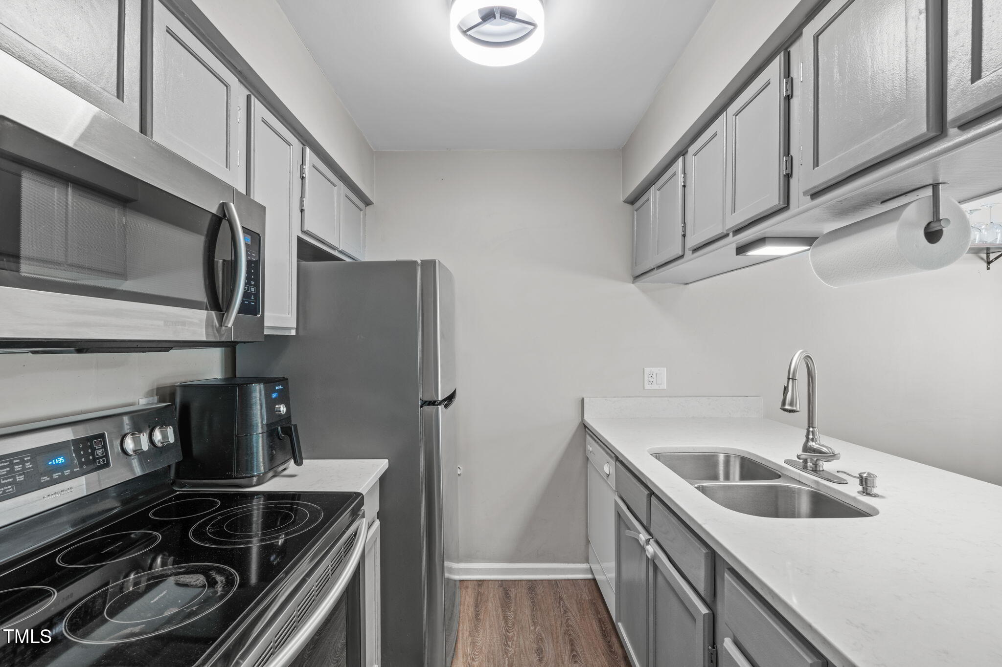 405 Gooseneck Drive, Unit B6 Cary, NC 27513 - Photo 10 of 26 a kitchen with stainless steel appliances granite countertop a sink stove and refrigerator