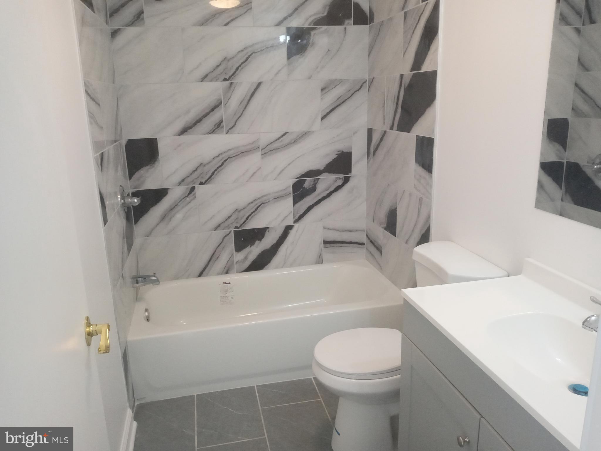 2990 Byrdtown Road Crisfield, MD 21817 - Photo 5 of 8 a bathroom with a sink a toilet and shower