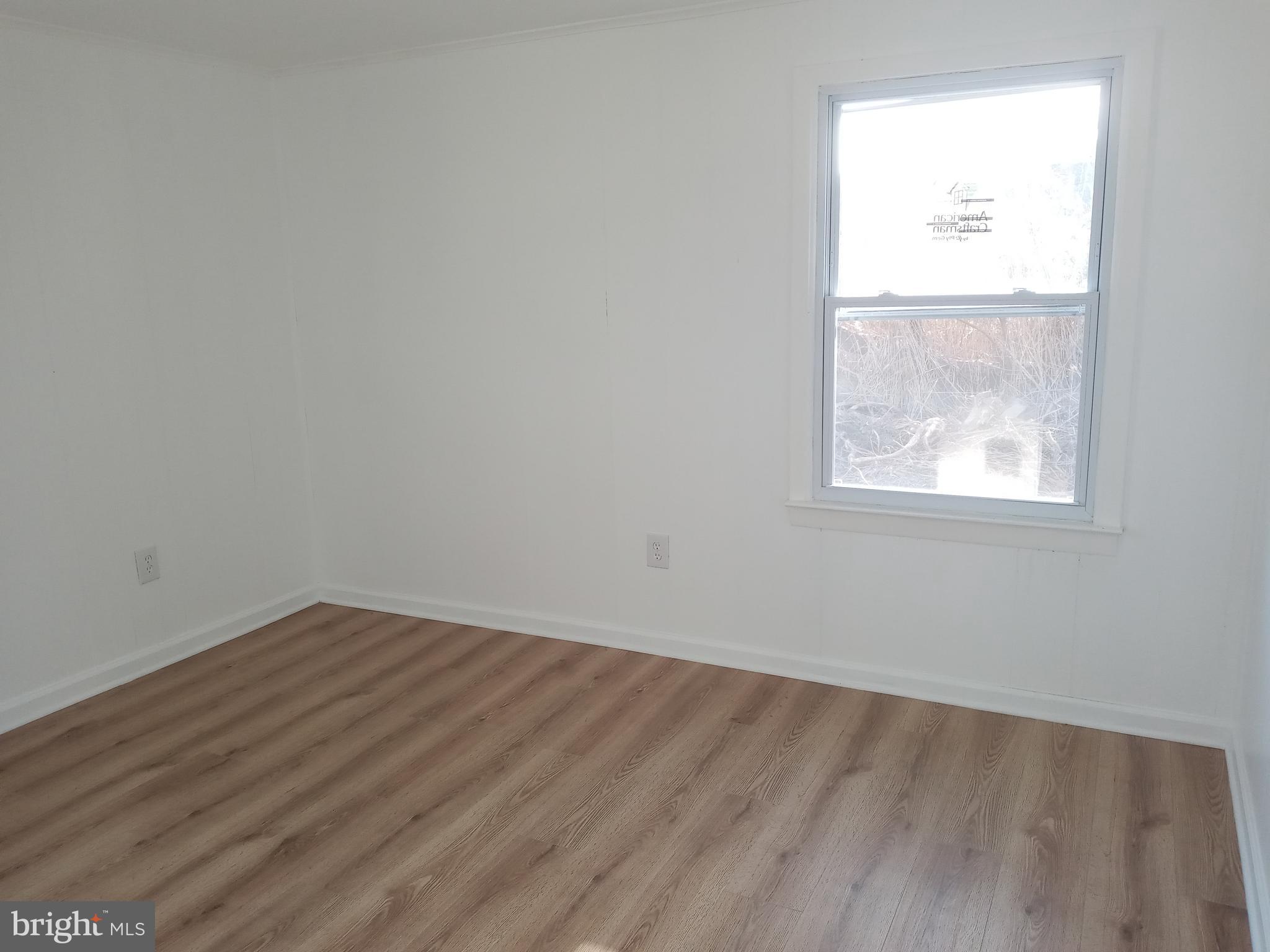 2990 Byrdtown Road Crisfield, MD 21817 - Photo 6 of 8 an empty room with a window