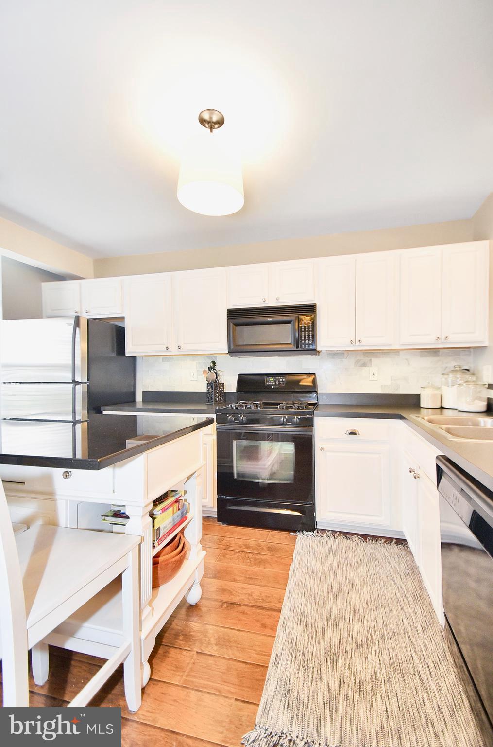 102 Peregrine Lane Hummelstown, PA 17036 - Photo 7 of 28 a kitchen with stainless steel appliances granite countertop a stove and a sink