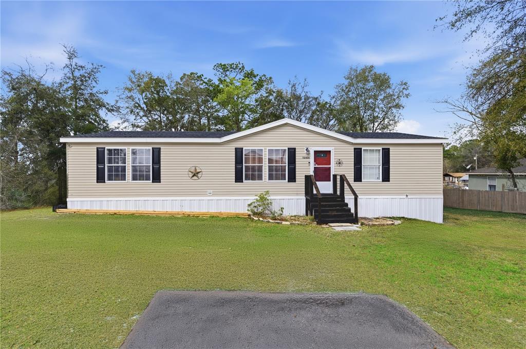 12400 Southeast 99th Terrace Belleview, FL 34420 - Photo 1 of 20 a view of a house with a swimming pool