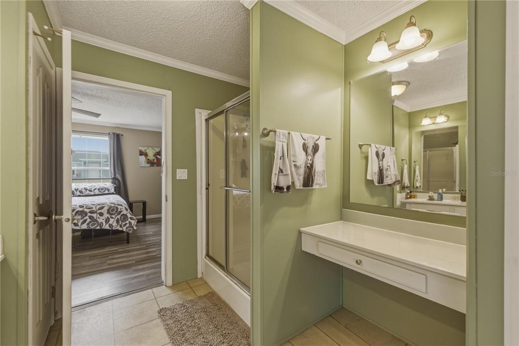 12400 Southeast 99th Terrace Belleview, FL 34420 - Photo 12 of 20 a bathroom with a glass door shower a sink and a mirror