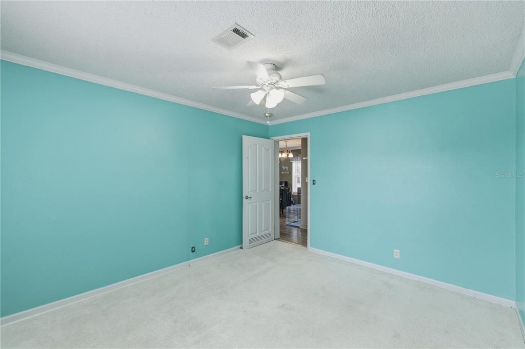 12400 Southeast 99th Terrace Belleview, FL 34420 - Photo 14 of 20 an empty room with a ceiling fan and a window