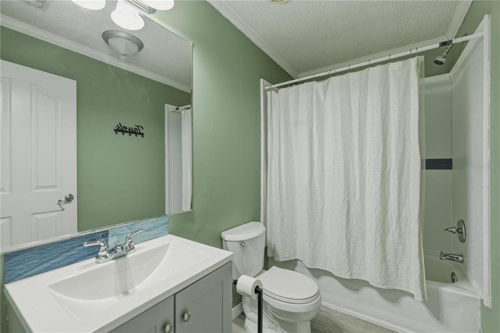 12400 Southeast 99th Terrace Belleview, FL 34420 - Photo 17 of 20 a bathroom with a sink a toilet and shower