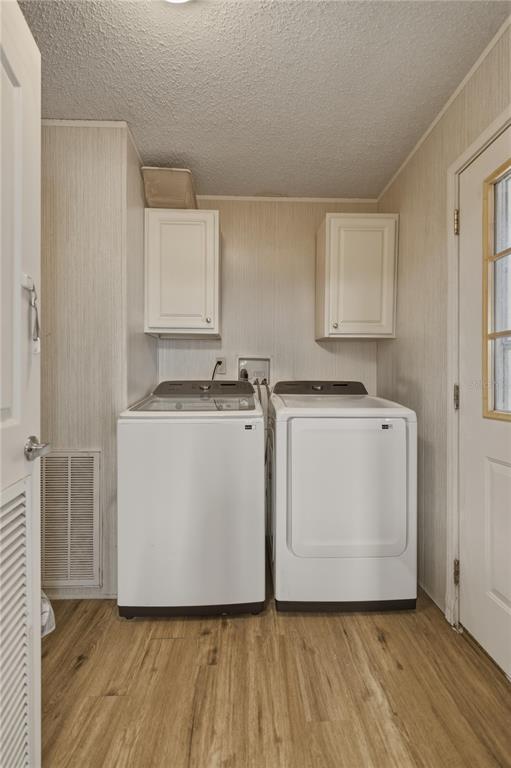 12400 Southeast 99th Terrace Belleview, FL 34420 - Photo 18 of 20 a utility room with cabinets washer and dryer