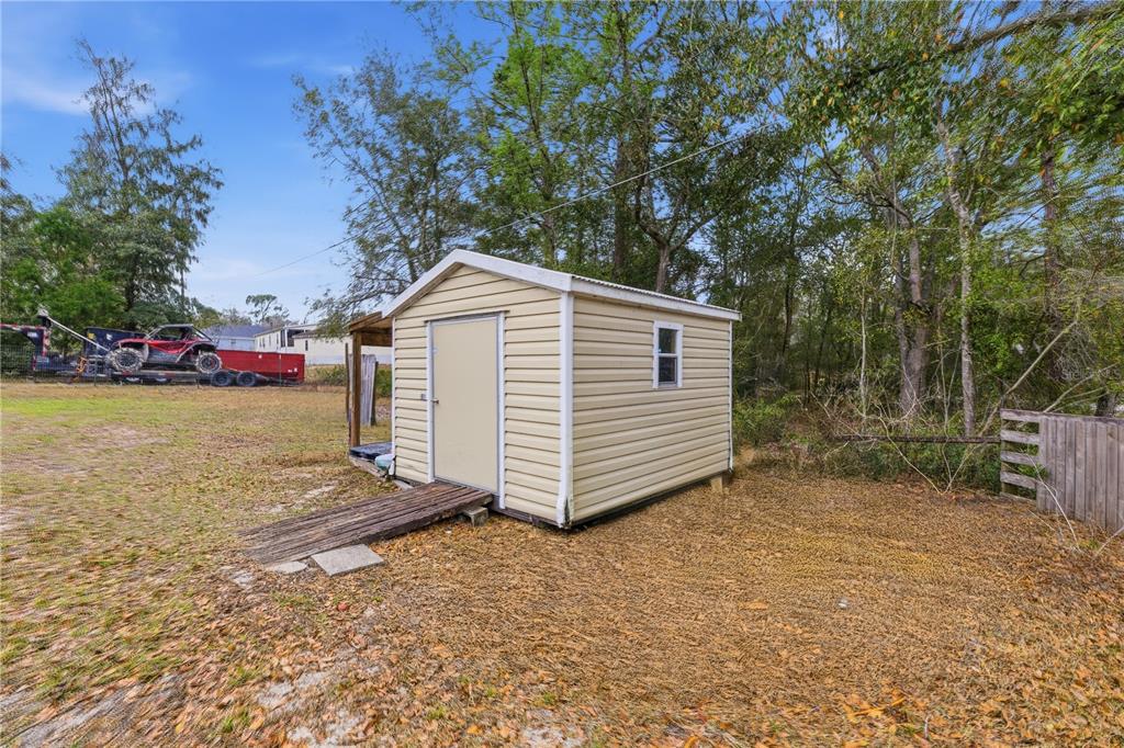 12400 Southeast 99th Terrace Belleview, FL 34420 - Photo 20 of 20 a view of a house with a yard and sitting area