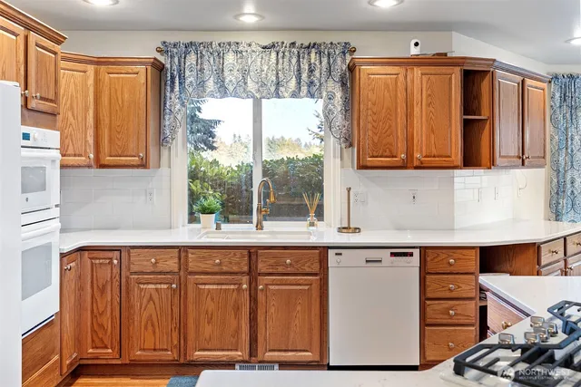 a kitchen with a sink a refrigerator and window
