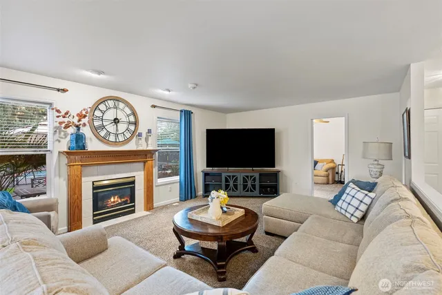 a living room with furniture a fireplace and a flat screen tv