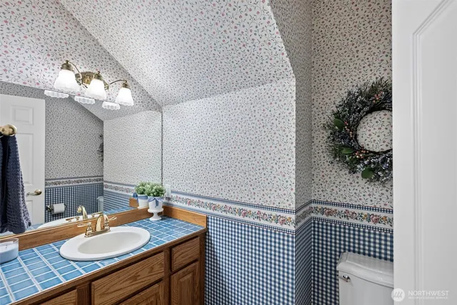 a bathroom with a sink vanity granite and a mirror
