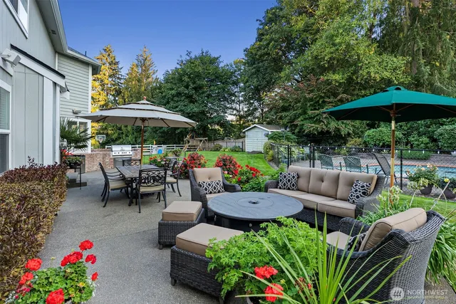 a view of a patio with furniture and a garden