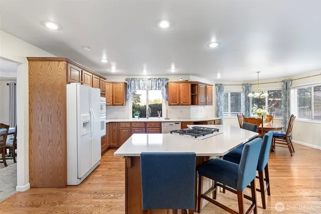 a large kitchen with a table and chairs